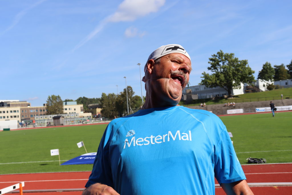 Nils Olav Larsen forsøker å få et strikk ned til halsen, uten å bruke hendene.