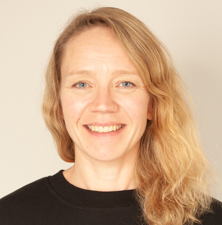 Kvinne med mellomblondt hår som smiler
